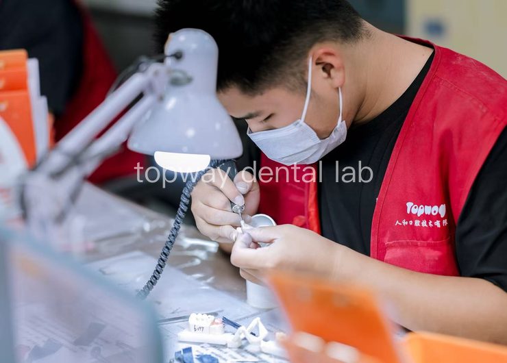 Dental technician finishing a restoration